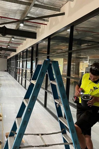 Auburn electricians installing down lights in Auburn store